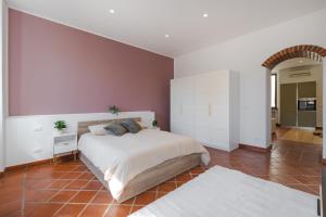 a bedroom with a large bed and a red tile floor at Marconi Home in Trieste +20 photos
