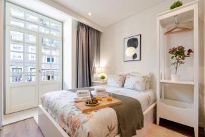 a bedroom with a bed and a table with fruit on it at Host Wise - Marquesa Palace in Porto +19 photos