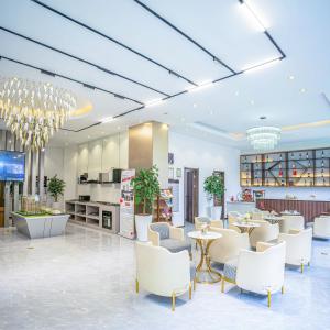 a lobby with white chairs and tables in a building at The Nestle & The Cradle - Kileleshwa in Nairobi