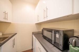 a kitchen with a microwave on a counter at Cozy Studio A C 2P - Saint-Tropez in Saint-Tropez
