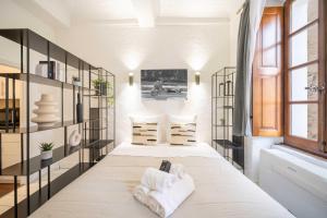 a bedroom with a large bed with towels on it at Cozy Studio A C 2P - Saint-Tropez in Saint-Tropez