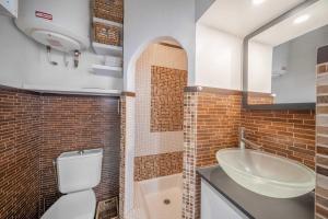 a bathroom with a sink and a toilet and a sink at Cozy Studio A C 2P - Saint-Tropez in Saint-Tropez