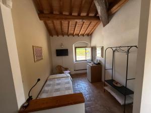 a room with a bed and a window at Poggio Savelli in Scarperia