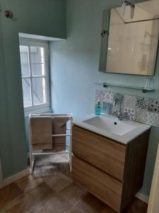 a bathroom with a sink and a window at La P'tite Place in Les Arques