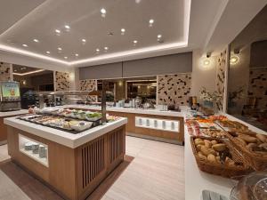 a kitchen with a buffet with many different types of food at Grand Hilarium Hotel in Istanbul