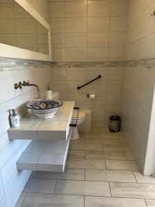 a bathroom with a sink and a toilet at The Gallery in Franskraalstrand