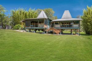 a large house with a large lawn in front of it at Rancho Crescent Head in Crescent Head