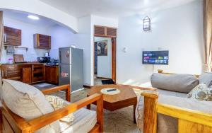 a living room with a couch and a table at Savannah Bstan Luxury Apartment in Diani Beach