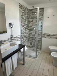 a bathroom with a shower and a sink and a toilet at Hotel Stella del Benaco in Manerba del Garda +12 photos