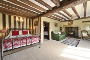 a bedroom with a bed and a fireplace at The William Penn At Wickham Manor in Winchelsea