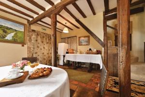 a room with a table with bread on it at The William Penn At Wickham Manor in Winchelsea