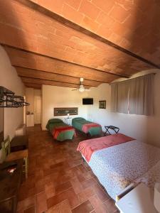 a room with three beds in a room at Poggio Savelli in Scarperia