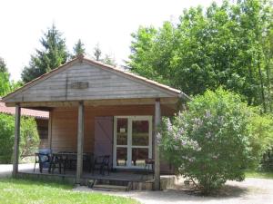 a gazebo with a table and chairs at Camping Le SIGNAL Nantua in Nantua