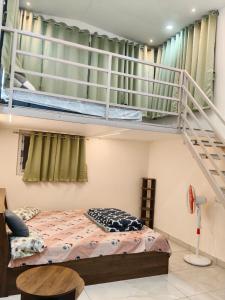 a bedroom with a bunk bed and a staircase at Cherish Farm Stay in Medchal