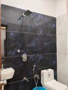 a bathroom with a toilet and a sink at Cherish Farm Stay in Medchal +129 photos