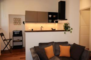 a living room with a couch and a kitchen at Dimora San Giorgio in Bolsena in Bolsena