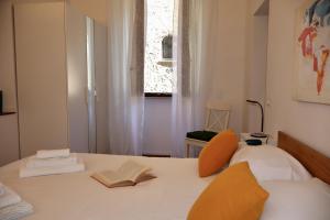 a bedroom with a bed with two books on it at Dimora San Giorgio in Bolsena in Bolsena