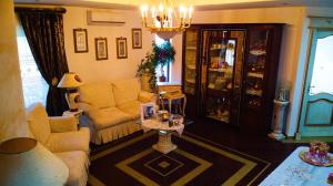 a living room with a couch and a chair at Happy Journey in Santa Elisabetta