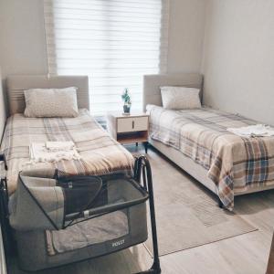 a bedroom with two beds and a window at Ankara Esenboğa Airport Comfort Apart in Ankara