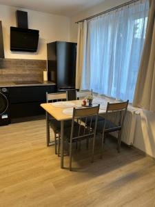 a dining room table and chairs in a room at Na Písku in Most