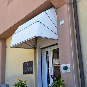 a white umbrella over a door of a restaurant at Piccolo Hotel in Lavagna