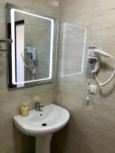 a bathroom with a sink and a mirror at Vila Bordei Verde in Mamaia Sat/Năvodari +38 photos