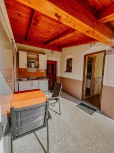 a kitchen with a table and chairs in a room at Apartment and Room Natasa in Kobarid