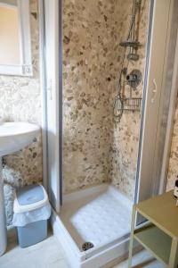 a shower with a toilet and a sink in a bathroom at Alloggio Turistico Porta di Poggio in Tuscania +31 photos