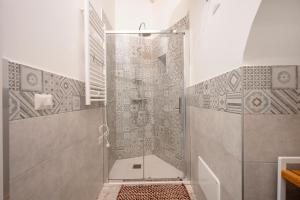 a shower with a glass door in a bathroom at Petit Maison Martini ' in Altamura