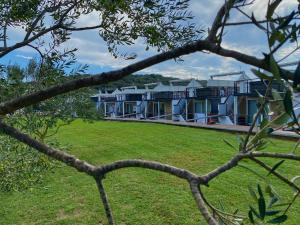 a row of blue houses with a green yard at Floating house Sunflower in Pula
