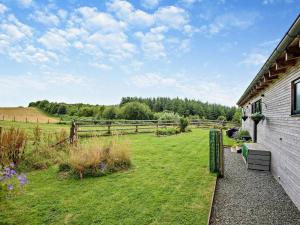 a house with a grass yard next to a fence at 2 Bed in Llandrindod Wells oc-53193 in Llandrindod Wells