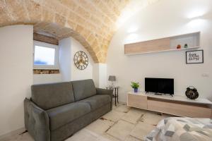 a living room with a couch and a tv at Petit Maison Martini ' in Altamura