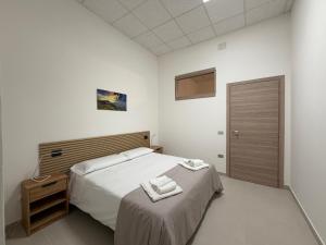 a bedroom with a bed with two towels on it at Guest House Colfiorito by Ospitaci in Colfiorito