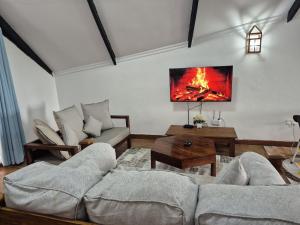 a living room with a fire in the wall at Savannah Bstan Luxury Apartment in Diani Beach