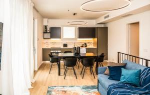 a living room with a blue couch and a table at Ariom Apartments in Moniga