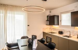 a kitchen with a table and chairs in a room at Ariom Apartments in Moniga