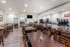 a dining room with wooden tables and chairs at Ramada by Wyndham Hinton in Hinton
