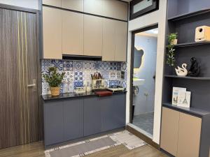 a kitchen with white cabinets and a counter at Dubai House in Hanoi
