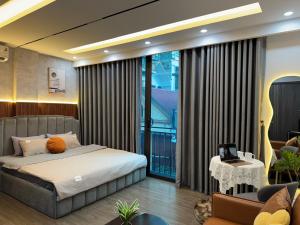 a bedroom with a bed and a balcony at Dubai House in Hanoi