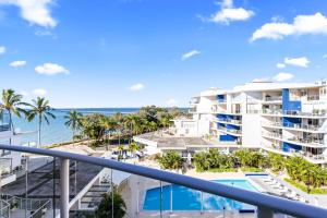 a view of the ocean from the balcony of a resort at Oceanfront Spa Suite - Sub Penthouse in Urangan