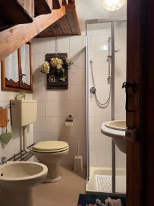 a bathroom with a toilet and a sink and a shower at Casa Angela-STAYERAT in Sequsino +59 photos