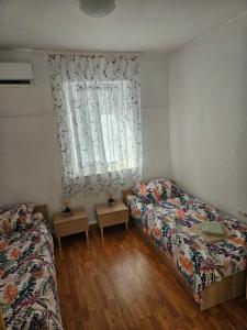 a bedroom with two beds and a window at APP EMONA in Bašanija