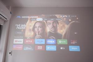 a large screen with a movie on a wall at Green West Lake Residence in Hanoi