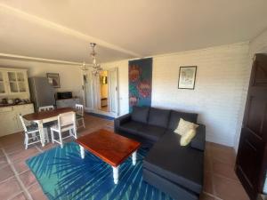 a living room with a couch and a table at Innisfree Manor in Somerset West