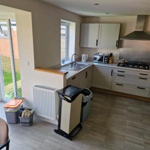 a kitchen with a sink and a counter top at Nairn Way House in Kirby Muxloe