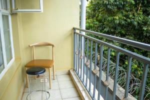 a chair sitting on a balcony next to a window at New Dawn luxury homes in Nairobi