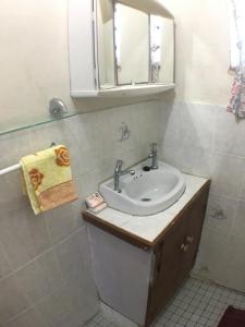 a bathroom with a sink and a mirror at Green Lodge Holiday Homes in Nuku‘alofa +66 photos