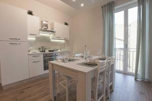 a kitchen with a table and chairs in a room at B&B Sikelia Suite in Agrigento