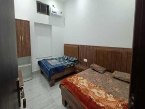 a room with two beds in a room at Hotel Maa Karni Darbar in Deshnoke