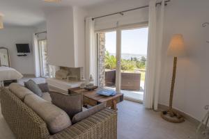 a living room with a couch and a table at Chrysalis Nature Villa 9 in Kampos Paros
